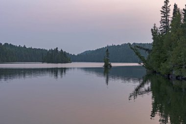 Diğer adam göl Quetico Provincial Park Ontario Kuzey ormanda alacakaranlıkta sakin suları