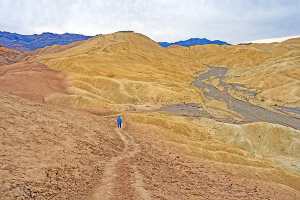 Hiking into a Lonely Desert Valley in the Golden Valley Near Zabriskie Point in Death Valley National Park in California