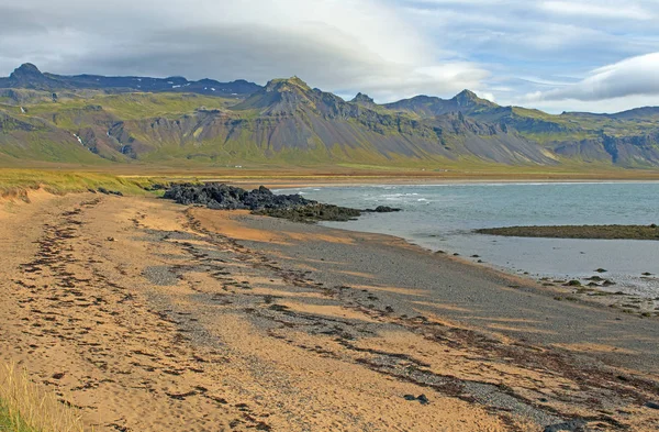 Golden Sand Beach with Lava and Mountains near Budir, Iceland on the Snaefellsnes Peninsula.
