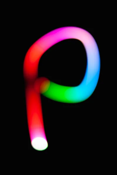 Letter P. Glowing letters on dark background. Abstract light painting at night. Creative artistic colorful bokeh. New Year. Use it for build you own design for book cover, CD, poster or post card.