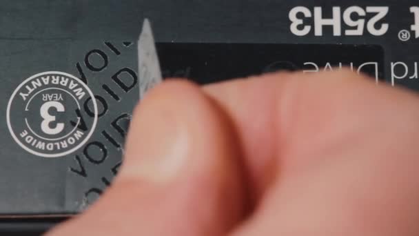 乌克兰第聂伯罗 2019年2月11日 在硬盘包装上贴有保修标签的贴面特写镜头 电影被顾客撕掉后出现无效 真正的原始包装 — 图库视频影像