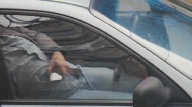Yorgun taksi şoförü, cep telefonunu elinde tutarken ya da park halindeki arabada uyurken. Siparişler akıllı telefonlardaki uygulamalar veya aramalar yoluyla alınır. Pencereden kapat. Mobil bağımlılık bağımlılığı