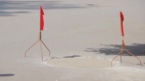 Des drapeaux rouges flottent sur les dessous de verre et avertissent de la présence de ciment frais sur la route. Travaux de réparation — Video