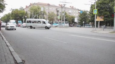 Arabalar yol boyunca koşturur. Toplu taşıma durağının yakınındaki kavşaklarda.