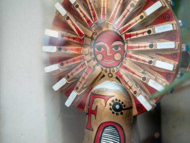 Moskova Kukla Tiyatrosu 'nun penceresindeki peri masalı kahramanlarını tasvir eden bebekler. Güneş gibi kırmızı yüzlü bir insan figürü. Karşıdaki binalar cama yansıyor.