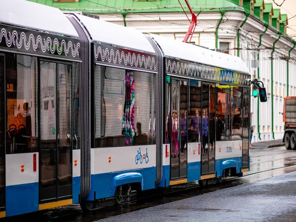 Moscow, Russia - October 19, 2019: Modern low-floor tram "Vityaz-M" on the path line. The coat of arms of Moscow is blue. Woman car driver in the cabin. — Stock Photo, Image