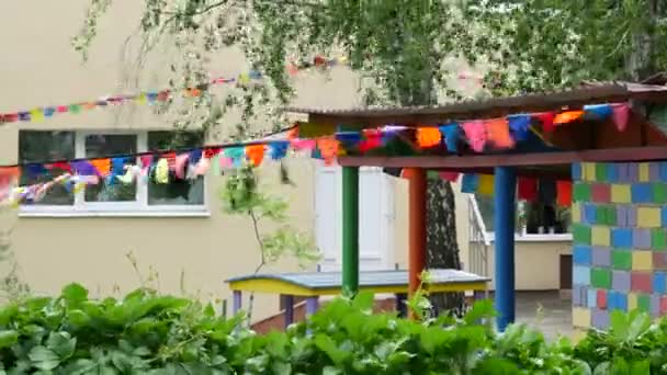 Bright colored flags flutter in wind on sunny warm day. Garland of party flags — Stock Video