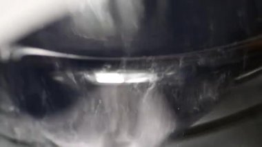 İşler modern çamaşır makinesinin davulunda dönüyor. Landromat 'ın cam kapısı.