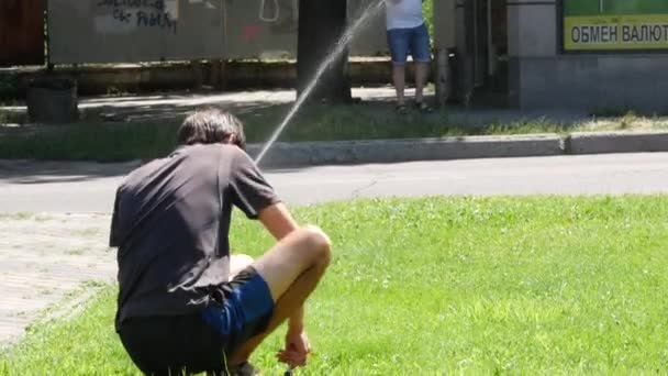Killen justerar finstämda jetmunstycken från fontänen. Arbetstagaren upprätthåller automatiskt system — Stockvideo