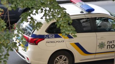 Beyaz Mitsubishi polis arabası yolda duruyor. Polis araçlarının özel renkleri