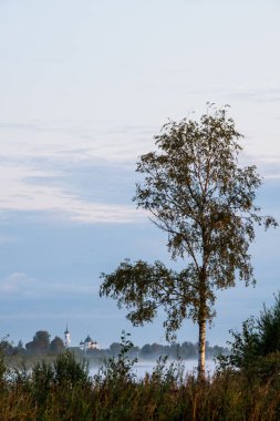 Puslu bir sabah şafak Nehri geçip kilisenin görünümü.