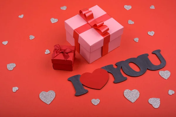 Gift and hearts on red background. Valentines Day. — Stock Photo, Image