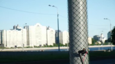 Şehirdeki restorandan yiyecek için sarı termos çantalı bir yemek dağıtıcısı elektrikli scooter 'a yaklaşır mobil uygulamadan kilidi açar ve işe gider. Ofise ve eve fast food servisi..