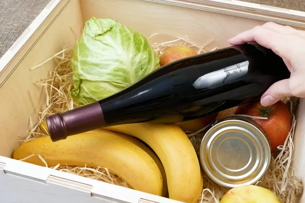 Organic Vegetables and fruits and wine in bottle in wooden box, online market, green grocery delivery at home concept, buy online concept