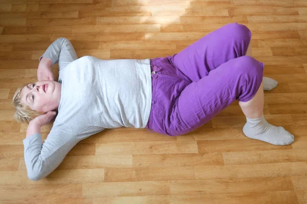 Woman doing physical exercises on the floor in the home, stay home concept, coronavirus covid-19 concept