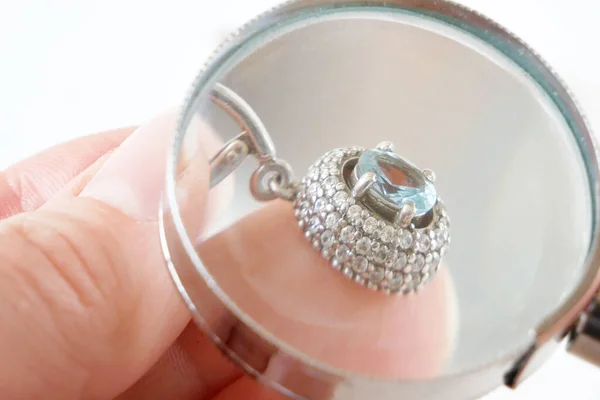 Hand Takes Earring Big Blue Topaz White Diamonds Jeweler Looking — Stock Photo, Image