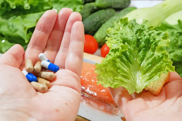 Healthy food vs pills. Salmon, vegetables and fruis vs medicine and drugs. Concept