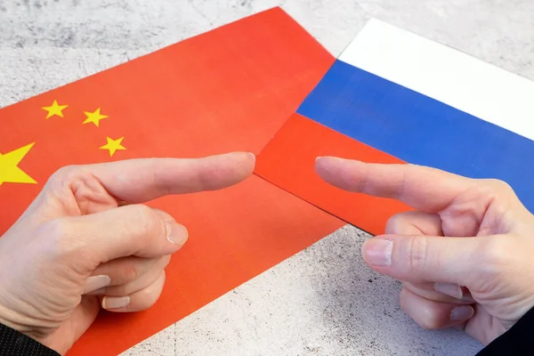 Russian Federation & China - disagreement, Russia and Chinese flags. Relationship conflict between Russia and China. Trade deal concept