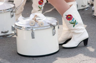 group of drummer girls in white Ukrainian costumes with traditional red ornament, Marching girl band drummers perform, drummers parade clipart
