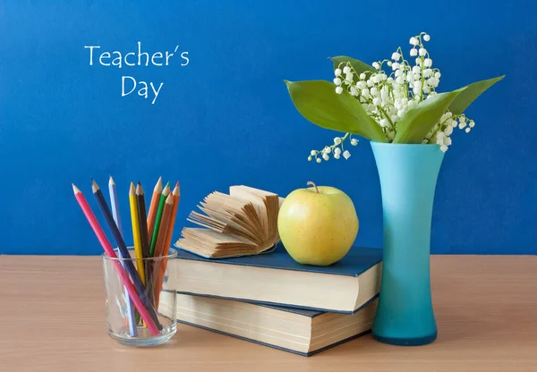 World Teacher\'s day concept. Flowers bunch, map, globe and books pile