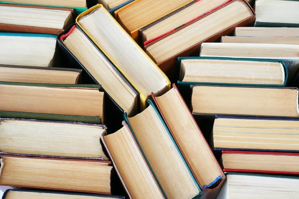 Big Book pile on green background, closeup