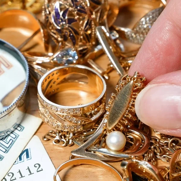 金と銀とお金のジュエリースクラップ 拡大鏡を通して宝石を見て質屋の概念の宝石商 ジュエリー検査と検証 — ストック写真