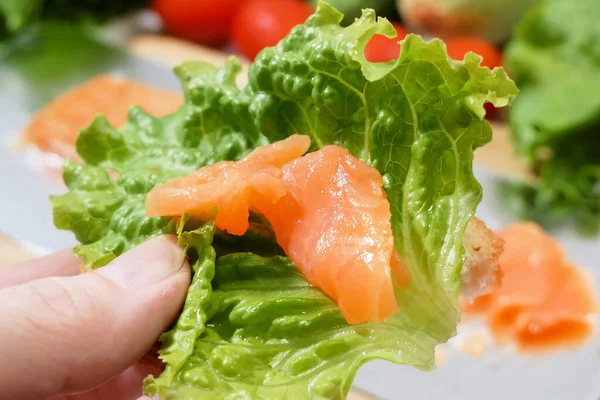 fresh salmon fish with green lettuce and vegetables, fresh salad with greens, salmon and croutons