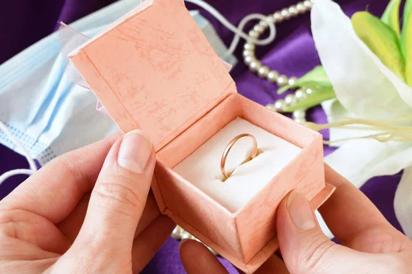 wedding rings in a gift box with flowers and pearl necklace
