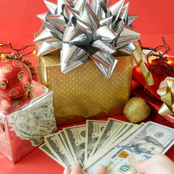 big gift box with ribbon bow and stack of money, merry chirtmas and happy new year concept