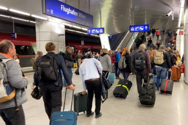 Vienna, Austria - August 3 2025: platform of railway train station and many people get on the elevator, indoors