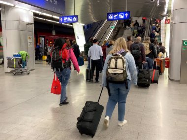 Vienna, Austria - August 3 2025: platform of railway train station and many people get on the elevator, indoors
