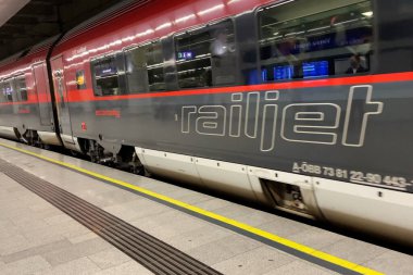 Vienna, Austria - August 3 2025 Modern high-speed assenger electric Reiljet train (BB) arrives at the railway station in urban landscape, outdoors