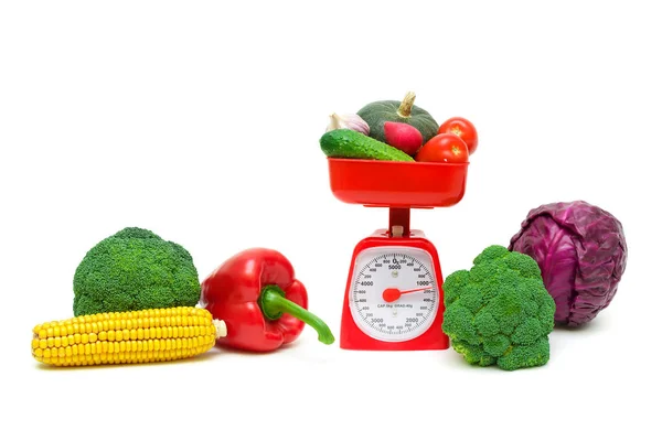 Fresh food and kitchen scales on a white background. — Stock Photo, Image