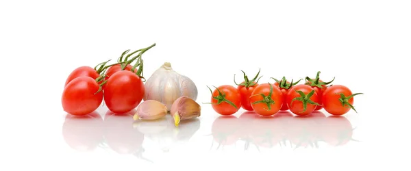 Различные помидоры и чеснок на белом фоне — стоковое фото