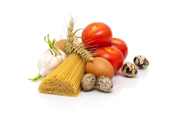 Rajčata, česnek, špagety a vejce na bílém pozadí — Stock fotografie