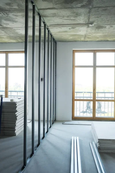 worker makes a wall out of drywall