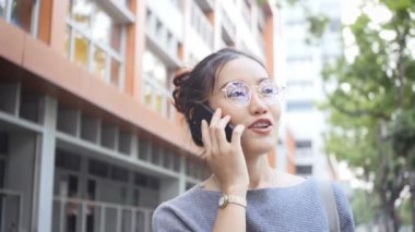 Kadın bir cep telefonu, sohbetler şehir sokaklarını arkadaşlarıyla oynuyor. Özel bir günde mutlu mu.