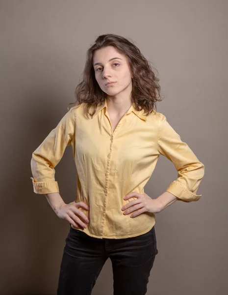 妇女在黄色衬衫在演播室在灰色背景 发言人系列概念 — 图库照片