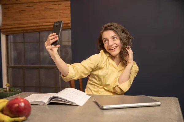 Young College Student Working in her kitchen taking a selfie — Stock Photo, Image