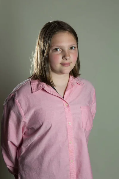 Eleven year old girl in oversized pink blouse — Stock Photo, Image