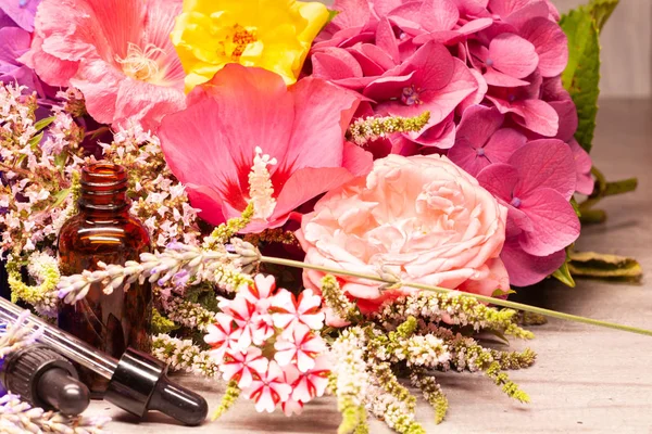 Spa composition of flowers and bottles of essential oils