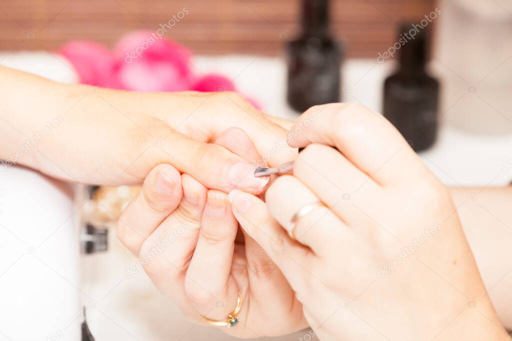 Applying nail polish on a woman's hands