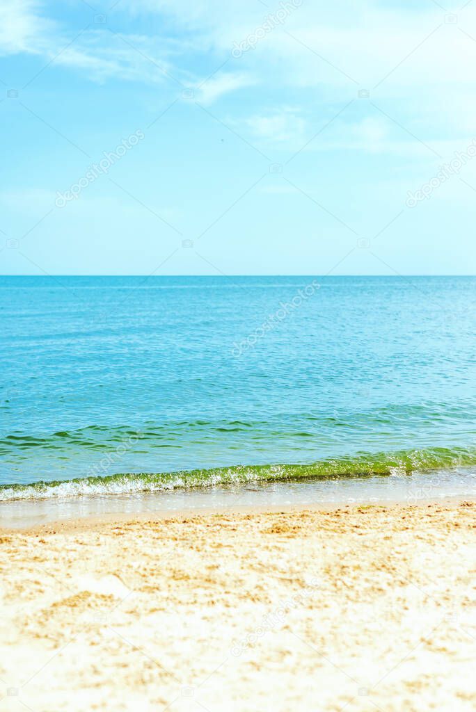 blue sea and sand beach under cloudy sky