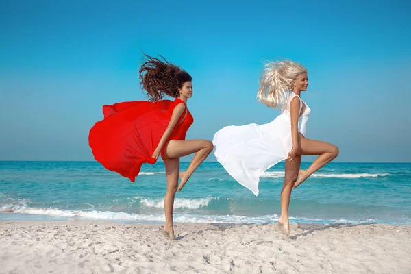 Two Beautiful Young Women Jumping Beach Colored Sarong Cheerful Girls — Stock Photo, Image