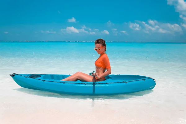 Sexy morena remando un kayak. Mujer explorando calma tropical ba —  Fotos de Stock