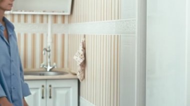 Genç kadın buzdolabı açar