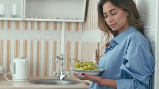 Молода жінка їсть зелений виноград — стокове відео