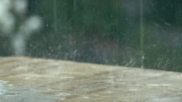 Drops of rain on garden table — Stock Video