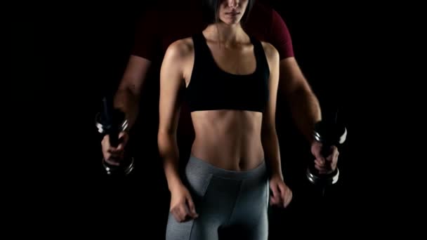 Male hand gives dumbbell to a woman — Stock Footage Male hand gives dumbbell to a woman Video Clip