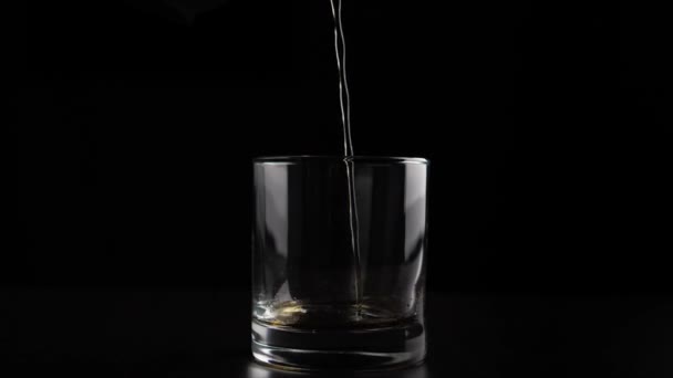 Verser de l'alcool brun dans du verre 